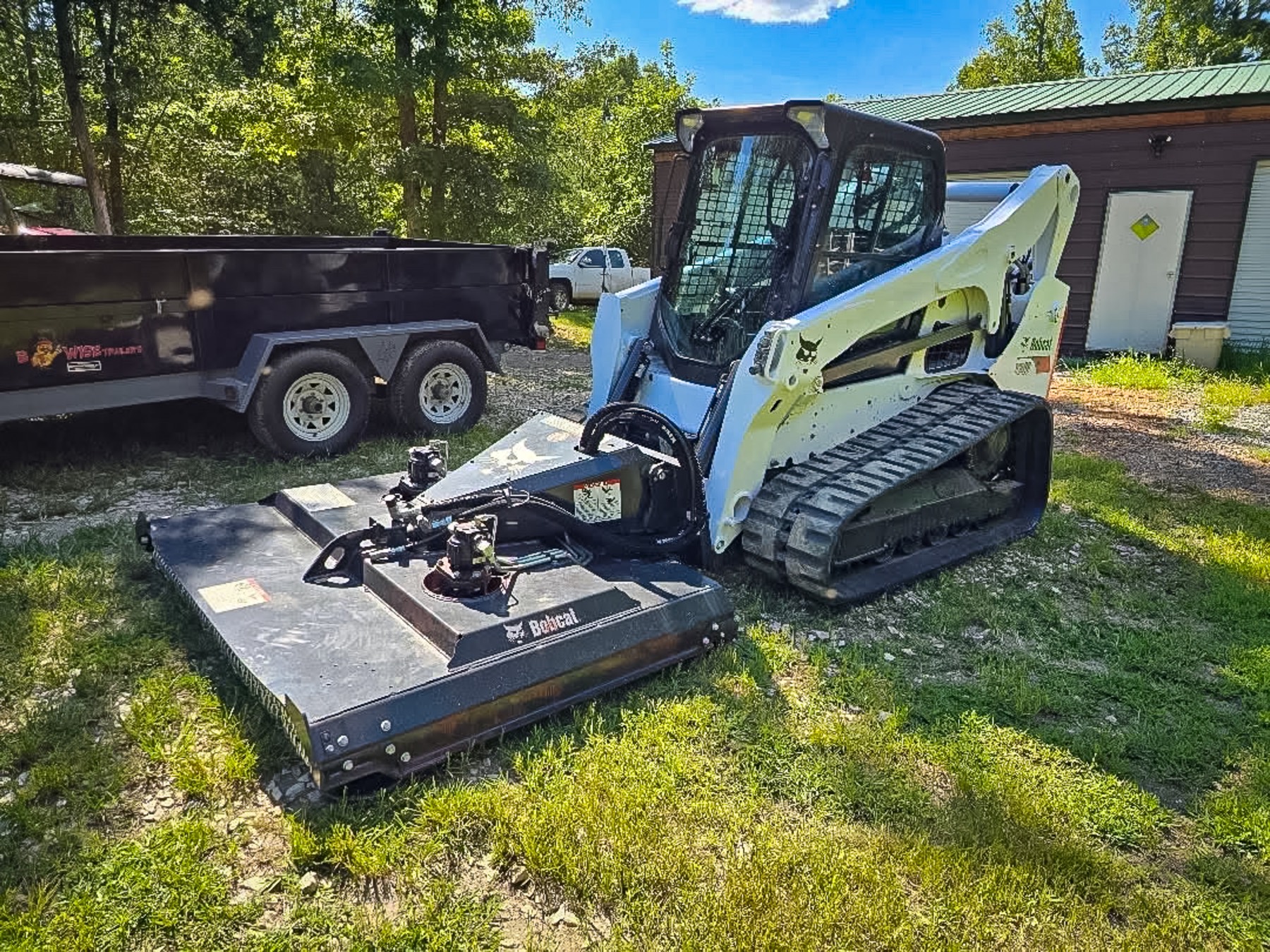 Bobcat T740 track loader equipped with a brush cutter attachment