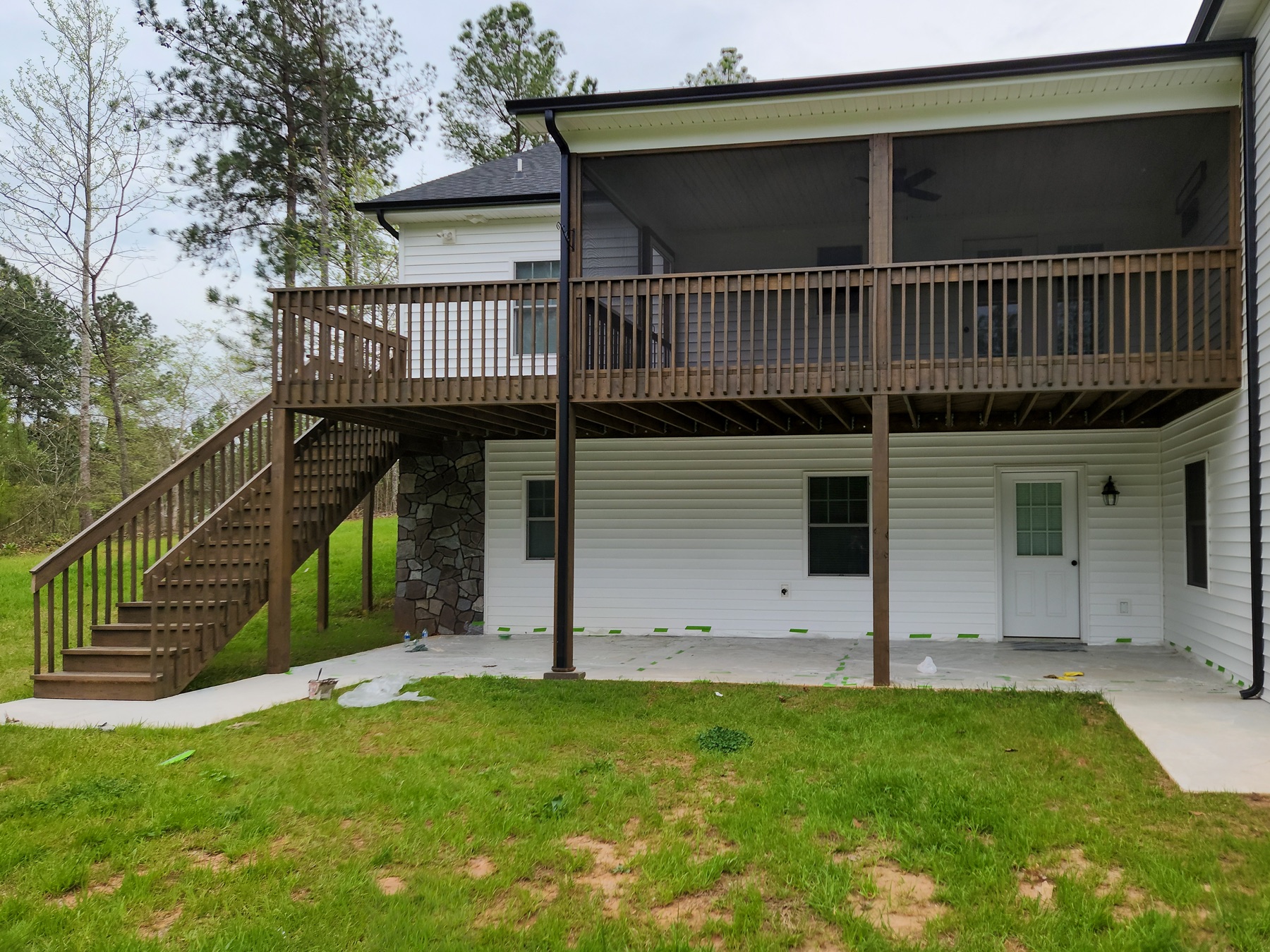 Elevated deck, stairs, and screened porch with a coordinated brown finish