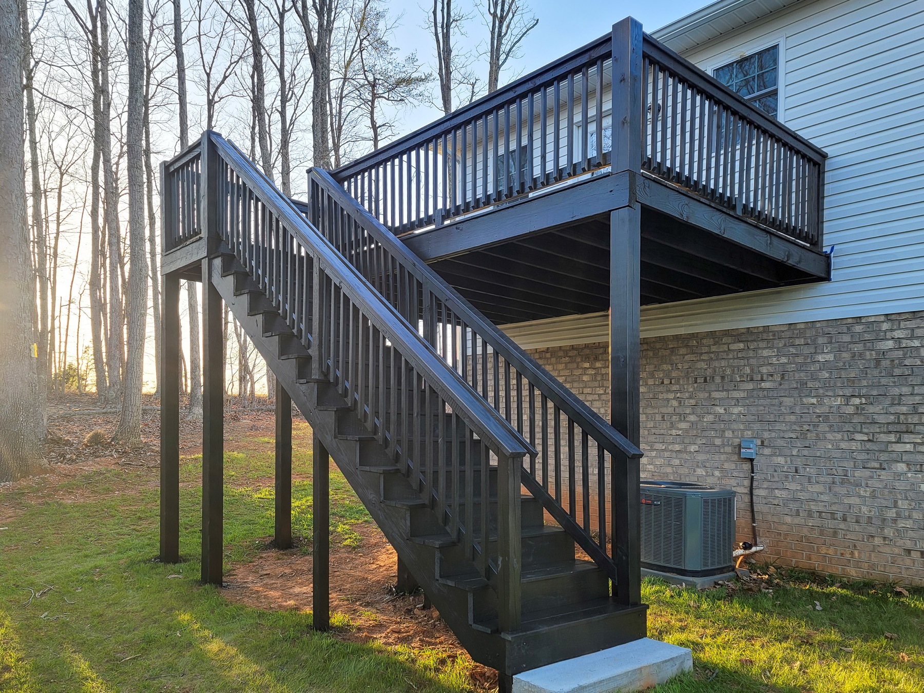 Elevated deck and stairs finished in a dark charcoal coating