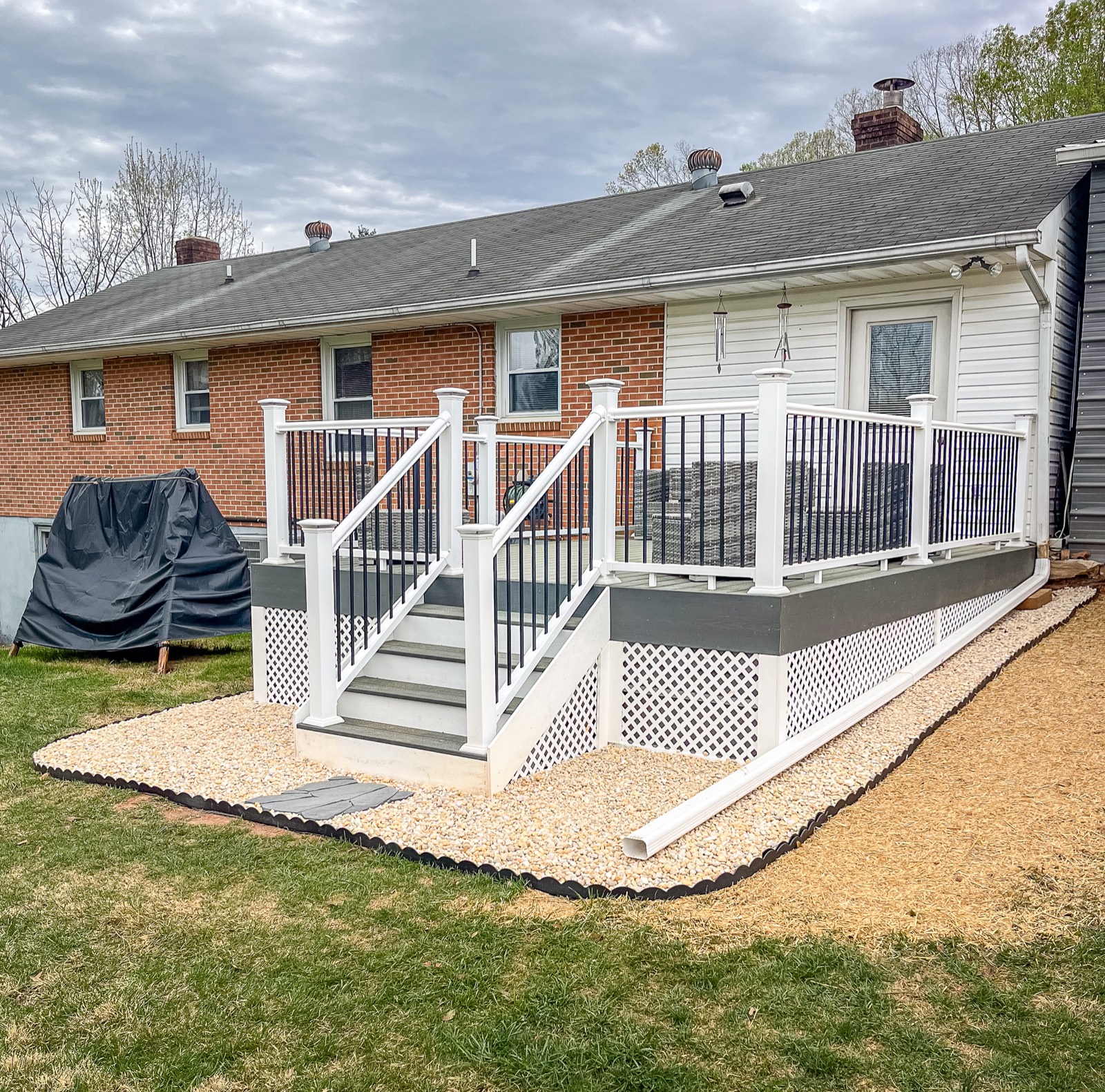 Completed composite deck with stairs, railings, and white lattice